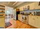 Well-equipped kitchen featuring stainless appliances, cream cabinetry, granite countertops, and an adjacent dining space at 22 Waters Bridge Cir, Covington, GA 30014