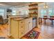 Open kitchen space includes cream cabinets, a black sink, stainless dishwasher, and views to living and dining areas at 22 Waters Bridge Cir, Covington, GA 30014