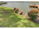 Exterior shot of a well-maintained lawn sloping down to the lake with carefully manicured landscaping at 22 Waters Bridge Cir, Covington, GA 30014