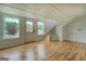 Bright living room with hardwood floors, paneled walls, and windows looking out onto the lake at 22 Waters Bridge Cir, Covington, GA 30014