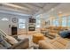 Comfortable living room with fireplace, shiplap walls and abundant natural light from windows at 22 Waters Bridge Cir, Covington, GA 30014