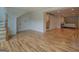 Open concept living room with light hardwood floors leading to the bedroom and bathroom at 22 Waters Bridge Cir, Covington, GA 30014