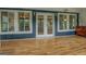 Covered porch featuring double glass doors, hardwood floors, and recessed lighting at 22 Waters Bridge Cir, Covington, GA 30014