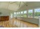Sunroom offering a tranquil lake view through its expansive windows and a ceiling fan for comfort at 22 Waters Bridge Cir, Covington, GA 30014