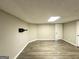 Basement featuring neutral walls, vinyl flooring, and a door leading to the outside at 4467 Thornwood Cres, Stone Mountain, GA 30083