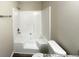 Bathroom featuring a luxurious soaking tub with a shower head, complemented by modern fixtures at 4467 Thornwood Cres, Stone Mountain, GA 30083