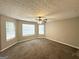 Spacious bedroom featuring plush carpeting, natural light from multiple windows, and a ceiling fan at 4467 Thornwood Cres, Stone Mountain, GA 30083