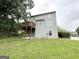 Backyard featuring a two-story house with a wooden deck and a concrete patio at 4467 Thornwood Cres, Stone Mountain, GA 30083