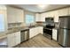 Modern kitchen with white cabinetry, stainless steel appliances, and granite countertops at 4467 Thornwood Cres, Stone Mountain, GA 30083
