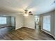 Open living room with wood floors and a view of the adjacent bathroom and hallway at 4467 Thornwood Cres, Stone Mountain, GA 30083