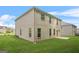 This home features a spacious backyard with a lush green lawn and brick exterior at 116 Cabin Way, Hampton, GA 30228