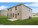 Exterior view of home showing brick facade, lush backyard with patio, and cooling system at 116 Cabin Way, Hampton, GA 30228