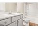 Clean bathroom featuring a single sink, white cabinets, granite counter, bathtub, and white toilet at 116 Cabin Way, Hampton, GA 30228