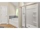 Bright bathroom featuring a soaking tub with stylish tile surround and a glass-enclosed shower with modern fixtures at 116 Cabin Way, Hampton, GA 30228