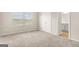 Bright bedroom with carpet flooring, double door closet, and bathroom entrance, offering ample space at 116 Cabin Way, Hampton, GA 30228