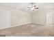 Carpeted bedroom featuring a ceiling fan, a doorway, and natural light from a window at 116 Cabin Way, Hampton, GA 30228