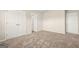 Spacious bedroom with neutral walls, carpet, a closet and entry door for easy access at 116 Cabin Way, Hampton, GA 30228