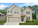Charming two-story home with a brick facade, attached garage, and well-maintained front lawn at 116 Cabin Way, Hampton, GA 30228