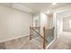 Upstairs hallway with carpet flooring and a staircase leading down at 116 Cabin Way, Hampton, GA 30228