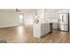 Open-concept kitchen featuring a center island with a sink and modern appliances at 116 Cabin Way, Hampton, GA 30228
