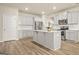 Bright kitchen with stainless steel appliances, light gray cabinets, and a large island at 116 Cabin Way, Hampton, GA 30228