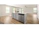 Bright kitchen with stainless steel appliances, light gray cabinets, and a large island at 116 Cabin Way, Hampton, GA 30228