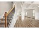 Bright living room with neutral walls, modern fireplace, and stunning staircase at 116 Cabin Way, Hampton, GA 30228