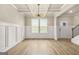 Open-concept living room featuring a decorative ceiling, wall paneling, and neutral paint at 116 Cabin Way, Hampton, GA 30228