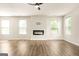 Spacious living room with fireplace, vinyl flooring, and lots of natural light at 116 Cabin Way, Hampton, GA 30228