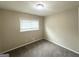 Comfortable bedroom with neutral walls, plush carpet, and natural light from the window at 815 Magna Carta Nw Dr, Atlanta, GA 30318