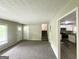 Bright living room with carpeted floors leads to an updated kitchen with modern stainless appliances at 815 Magna Carta Nw Dr, Atlanta, GA 30318