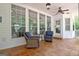 Relaxing back porch with ceiling fan and wicker chairs, ideal for outdoor living at 120 Hamilton Glen Ct, Fayetteville, GA 30215