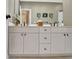 Bathroom featuring double sink vanity with granite countertop, decorative hardware, and stylish decor at 120 Hamilton Glen Ct, Fayetteville, GA 30215