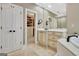 Bright bathroom featuring a soaking tub, custom vanity and walk-in closet access at 120 Hamilton Glen Ct, Fayetteville, GA 30215