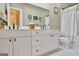 Well-lit bathroom with a double sink vanity, framed mirrors, and a shower-tub combination at 120 Hamilton Glen Ct, Fayetteville, GA 30215