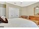 A well-lit bedroom featuring a comfy chair, dresser, and ample closet space for organization at 120 Hamilton Glen Ct, Fayetteville, GA 30215