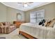 Cozy bedroom featuring a wood dresser, window with blinds, and a plush armchair at 120 Hamilton Glen Ct, Fayetteville, GA 30215