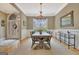 Formal dining room with wood table, chairs, chandelier, and natural light at 120 Hamilton Glen Ct, Fayetteville, GA 30215