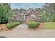 Charming brick home featuring lush landscaping and a well-manicured front yard at 120 Hamilton Glen Ct, Fayetteville, GA 30215
