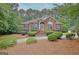 Charming brick home featuring lush landscaping and a well-manicured front yard at 120 Hamilton Glen Ct, Fayetteville, GA 30215