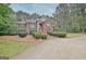 Charming brick home featuring lush landscaping and a well-manicured front yard at 120 Hamilton Glen Ct, Fayetteville, GA 30215