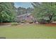 Charming brick home featuring lush landscaping and a well-manicured front yard at 120 Hamilton Glen Ct, Fayetteville, GA 30215