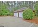 Detached two-car garage featuring brick exterior and adjacent driveway at 120 Hamilton Glen Ct, Fayetteville, GA 30215