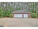 Full view of two-car garage with white overhead doors and long driveway at 120 Hamilton Glen Ct, Fayetteville, GA 30215