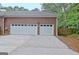 Front view of the two-car garage with two white overhead doors and driveway at 120 Hamilton Glen Ct, Fayetteville, GA 30215