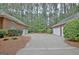 A long driveway leads to two separate two-car garages, each matching the home's brick exterior at 120 Hamilton Glen Ct, Fayetteville, GA 30215