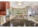 Large kitchen island with cooktop and granite countertops in an open-concept kitchen at 120 Hamilton Glen Ct, Fayetteville, GA 30215