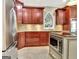 View of the kitchen featuring cherry wood cabinetry and stainless steel appliances at 120 Hamilton Glen Ct, Fayetteville, GA 30215