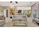 Open-concept living room featuring a fireplace, stylish sofa, and seamless access to the kitchen at 120 Hamilton Glen Ct, Fayetteville, GA 30215