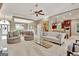 Expansive living room featuring neutral tones, ceiling fan, and seamless access to dining and kitchen areas at 120 Hamilton Glen Ct, Fayetteville, GA 30215